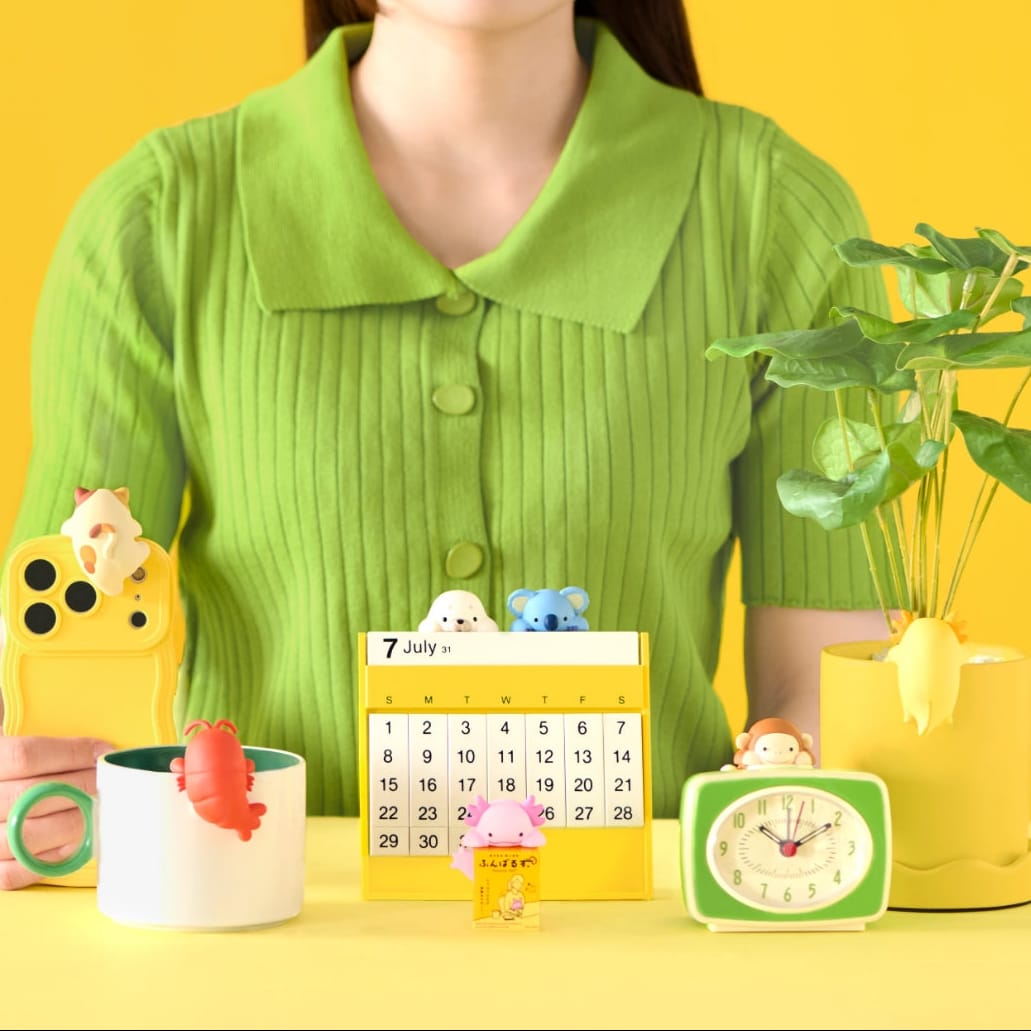 A collection of cute animal hippers attached to various household objects like a calendar and a mug.