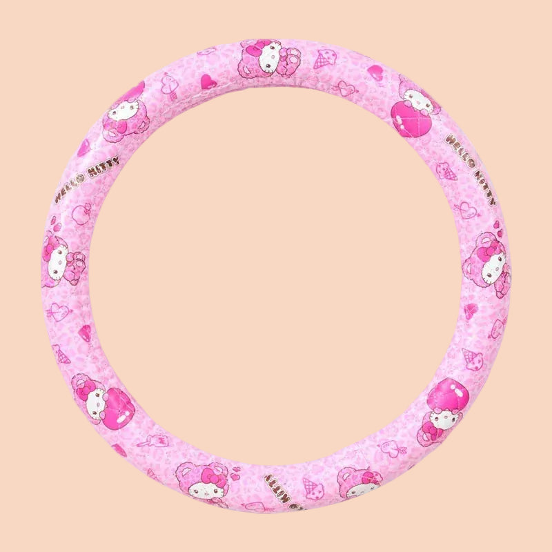 A black cover for a steering wheel with illustrations of Hello Kitty on it.