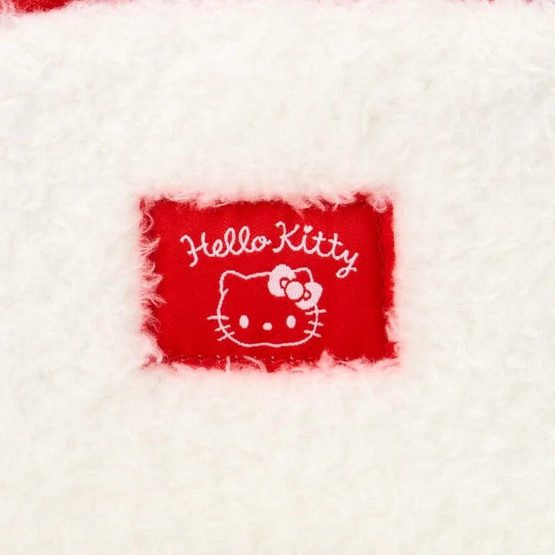 Close-up of white fabric with 'Kuromi' label featuring a character design.