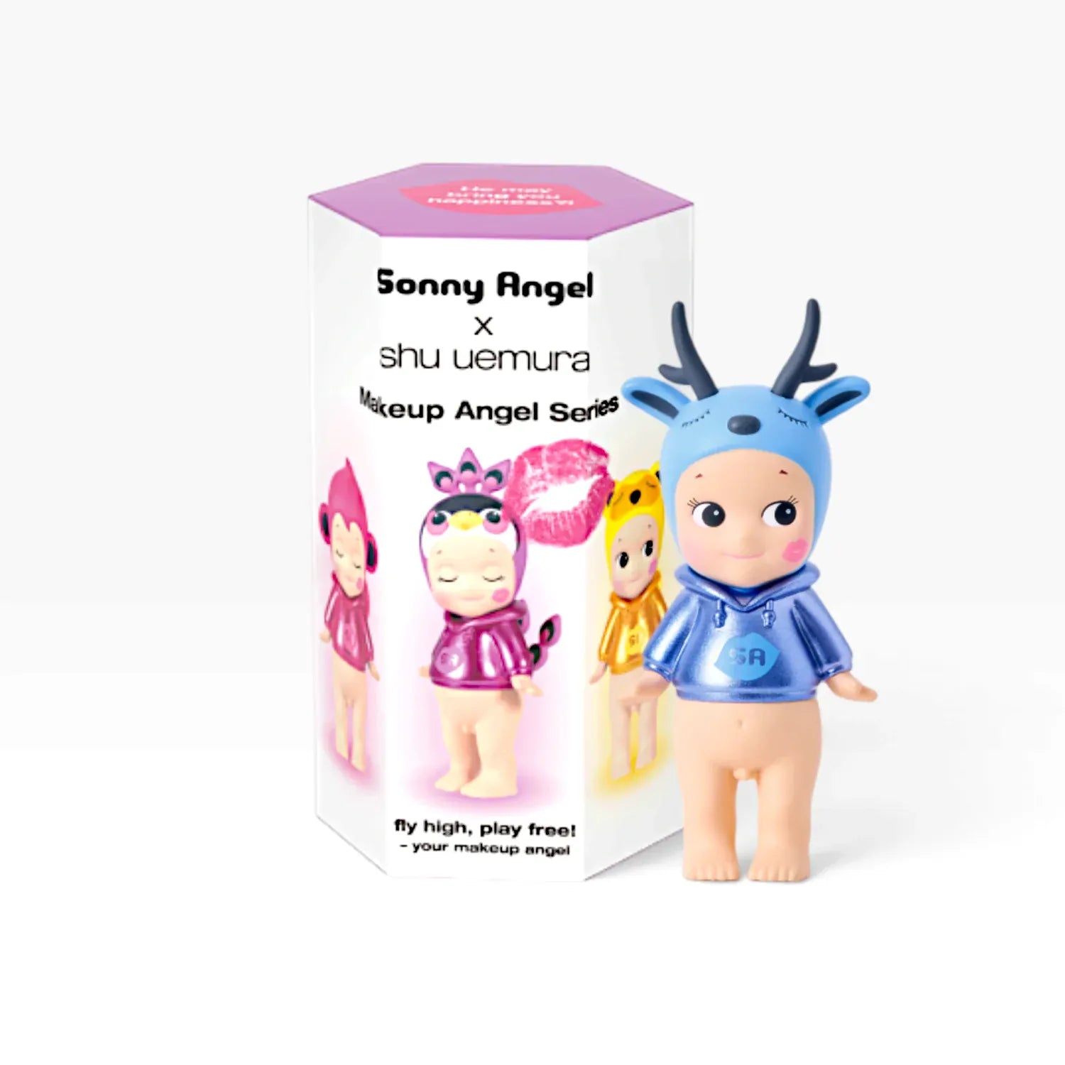 Sonny Angel blind box next to a figure dress in a hoodie and a deer blue hat, with horns and sleepy closed eyes.