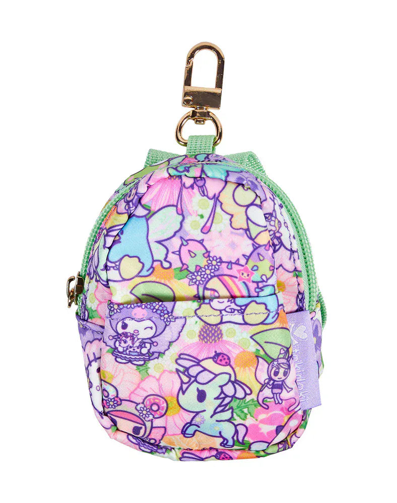 Miniature backpack with colorful tokidoki characters and light green straps.
