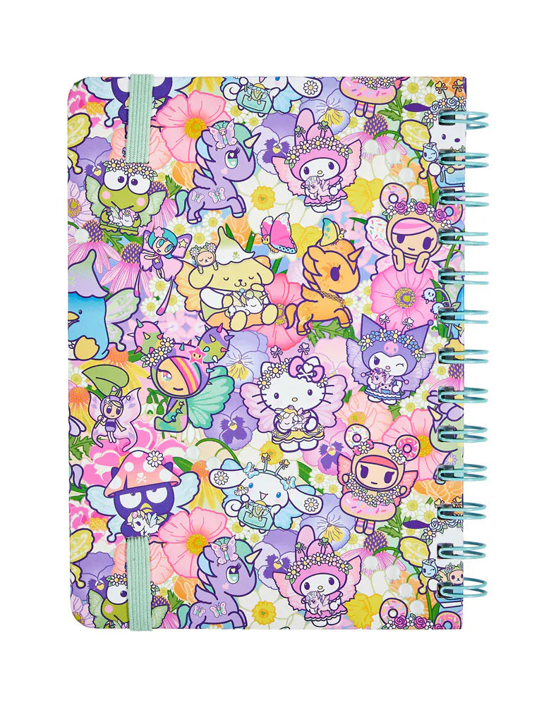 A notebook with colorful illustrations of various tokidoki characters over a background of flowers on its back cover.
