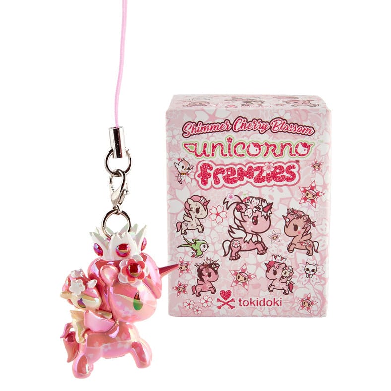 A picture of a pink unicorn key chain beside a pink box with pictures of other unicorns on it. The box has text reading "Unicorn Frenzies".